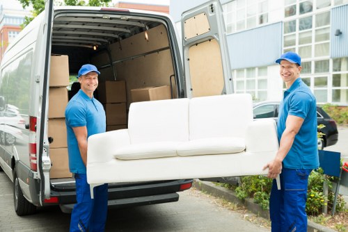 Professional flat removal service in Woodsidepark with moving boxes and furniture