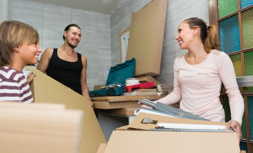 Removal and storage service planning in Woodsidepark with moving boxes and organized furniture
