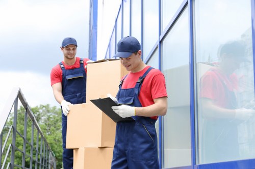 Moving team handling apartment items during a Woodsidepark flat relocation